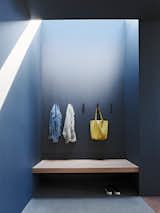 A custom bench in the mudroom is illuminated by a skylight.