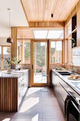 "Everyone who visits speaks of the warmth created by the timber lining boards and the interest of the raked ceiling in the kitchen,” says homeowner Sarah.