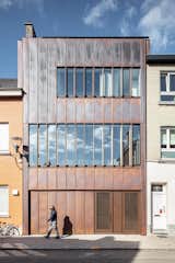 Copper cladding will patina over time. Horizontally articulated windows and standing seams give the facade a sleek, streamlined presence.