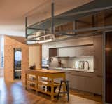 This island brings together the various materials of the room and also offers storage space and a butchers block top. 