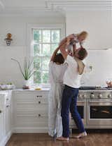 Leanne, husband Erik, and daughter Ever, playing together in their beautifully renovated kitchen.&nbsp;