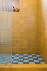 Reeded glass lets the colorful tiles in the upstairs bathroom show through.&nbsp;