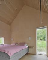 Plywood panels reach up to the high ceilings in every room. 