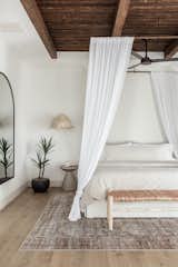 Potted faux plants, like this Afloral tropical yucca tree plant, are a smart option for adding easy-to-maintain and pet-safe greenery to your home.  Photo 1 of 40 in Bedroom by Tracyann Lek from Are These Faux Flowers the Real Secret to a Sophisticated Home?