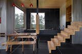 Patnaik chose simple black tiles instead of stone for the floor because stone would've made the structure too heavy for the stilts it sits on. 
