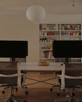 In the atelier, you'll find a long table with monitors and ergonomic chairs, plus industrial shelving to store some of the packaging Wedge has designed. 