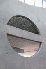 The stone finish contrasts against modern, Brutalist applications of concrete. 