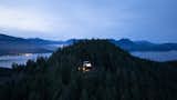 The cabin is a glowing jewel at night on a hilltop on the remote Keats Island in British Columbia, Canada.