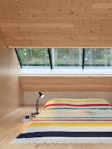 While homeowners Chadd and Sean wait to find just the right bed frame, they happily make do with a mattress under a Hudson's Bay blanket—an iconic piece of Canadiana—in the wood-panelled loft.