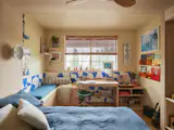 Will’s material palette combines raw plywood, warm sandy paint, and pops of Dazzling Blue tiles, with most color coming from vintage surf magazines and record artwork.&nbsp;