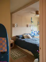 Will's custom capsule bed, inspired by The Public hotel in NYC, creates a cozy sleeping nook wrapped in warm plywood that feels both modern and surf-shack casual.