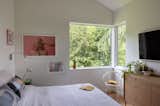 Color Boom swing-arm sconces by Dutton Brown offer flexible bedside lighting.