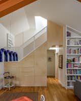 Floor-to-ceiling built-in shelving by Kable Design Build houses the family’s beloved books. The area under the stairs has built-in cabinetry for additional storage.