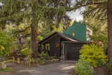 The new second-story addition, clad in Hardie lap siding and painted in Benjamin Moore Deep Sea, creates a bold contrast with the existing home’s cedar shingles in Black Panther.