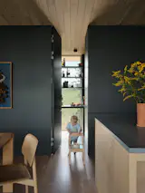 A generous pantry accommodates the family's canning supplies, with child-height storage for easy access to snacks.