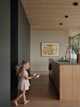 White oak cabinetry and concrete countertops by Béton Johnstone make for a sleek, streamlined kitchen design. 