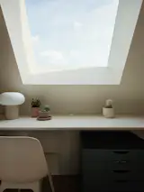 A skylight illuminates a home workspace. 