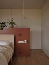 A Luminaire Authentik fixture hangs above Camille and Alexandre's bed.