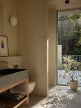 Natural white cedar ceiling cladding adds warmth and texture throughout the interior spaces—even in the bathroom.