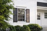 The original cedar siding presented a host of typical wood-related issues, such as water absorption, rot, and insect problems, all of which required constant maintenance and eventual replacement.  Photo 2 of 7 in A Colonial-Style Home Gets a Second Life Without Losing Its Charm