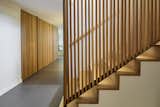 The slatted wall that lines the stairs is echoed by the wall that encloses the sitting room. 