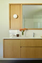 Artemide Dioscuri Wall Globe sconces were used in all three of the home's bathrooms. 