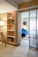 Curved corners lead the eye through the space, establishing a visual language that makes the apartment feel generous despite its modest square footage.