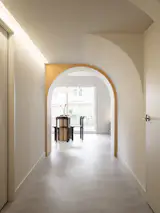 Sculptural curved ceilings hide rerouted mechanical systems throughout the apartment, turning technical necessity into architectural rhythm that gives depth and flow to the space.