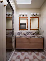 Classic materials like marble, tile, and wood are used throughout this Carroll Gardens brownstone, but applied to modern, streamlined forms like this clean-lined floating vanity. “When you get that mix right, the bathroom feels both timeless and totally usable day to day,” says Slocum.