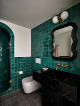 One of the full bathrooms in this Carroll Gardens reno features a gorgeous turquoise tile by Clé. The high-gloss finish reflects the light and helps the room feel multi-dimensional and warm. 