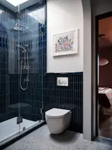 In this Bed-Stuy brownstone originally designed by Brooklyn's first female architect, Susanna E.C. Russell, the Brownstone Boys paired historic details with modern functionality. The Geberit Duofix In-Wall System frees up to nine inchers of floor space compared to traditional toilets, while the Sigma20 flush plate complements the design with a clean, understated presence. The Sigma20's dual-flush technology and matte, fingerprint-resistant finish in black complement the home's Berlin-inspired aesthetic, blending seamlessly with deep blue tiles and moody contemporary touches. 