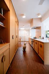 Fireclay tiles wrap the kitchen island and backsplash, their handmade edges carefully composed to avoid cut tiles at transitions. 
