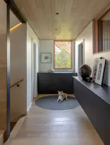 Ikea cabinets hang off a wall in the upper hall, adding even more storage and creating a visual connection to the kitchen.