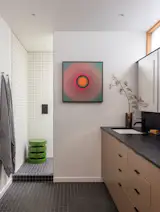 Daltile covers the primary bathroom walls—a low-cost-per-square-foot choice that maximized tile coverage within budget.