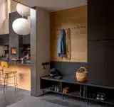 The entryway features floor-to-ceiling Ikea storage with Caesarstone quartz offcuts forming both the bench-top and backsplash.