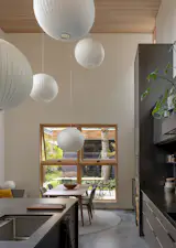 Herman Miller Nelson Ball Bubble pendants float above a Case Dulwich Extension dining table and JOBS Bacco chairs, like a bevy of hot air balloons.