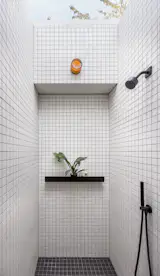 The primary shower features Daltile tiles and Artos fixtures, and, most excitingly, a skylight. It doesn't just let in the light: it opens right up to the sky, (nearly) fulfilling Daren's dream of an outdoor shower. 