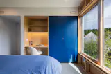 Baltic birch cabinetry and an integrated desk maximize the modest bedroom's efficiency. 