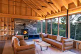 Le Corbusier sofas with chrome frames and leather cushions anchor the space before the hearth, where a second Muskoka Tide marble slab grounds the room. 