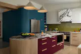 Calacatta Viola Laminam porcelain tops the island and wraps the vent hood. Article's Aino pendant lights illuminate the space.