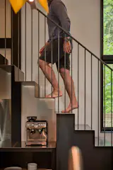 Custom steel railings integrate with the stair's structural frame.