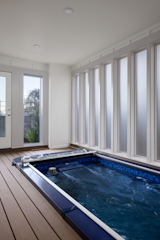 Indoor swim spa at home.