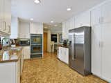Custom kitchen with Fireclay hand painted tiles, cork floor and end grain butcher block