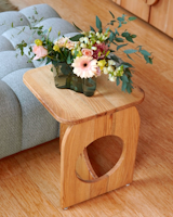 This custom design can be used as a side table or a stool for the nearby dining table.
