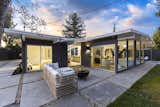 Outdoor, Trees, Shrubs, Concrete Patio, Porch, Deck, Grass, Back Yard, Hardscapes, Vertical Fences, Wall, and Wood Fences, Wall  Photo 18 of 20 in The Strawberry 94087 Eichler by Boyenga Team
