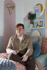 The pastel palette of Bradley’s room borrows from his graphic prints behind him. The young designer pulls inspiration from many famous artists, creating an eccentric room full of personality.