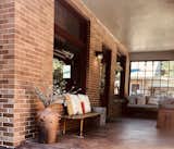 retaining the original brick and cozy porch for indoor/outdoor living.  Built in heaters allow extended use (important during coronavirus!)