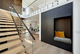 Ascend the floating staircase to discover a the open floor plan of the voluminous living area.
