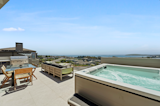 A capacious balcony boasts panoramic ocean and buy views, a gas grill and spa tub.