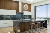 A state-of-the-art kitchen features premium appliances, custom cabinetry and a large island, perfect for culinary enthusiasts. 